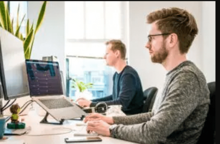 Two men working on computers, GTD method.